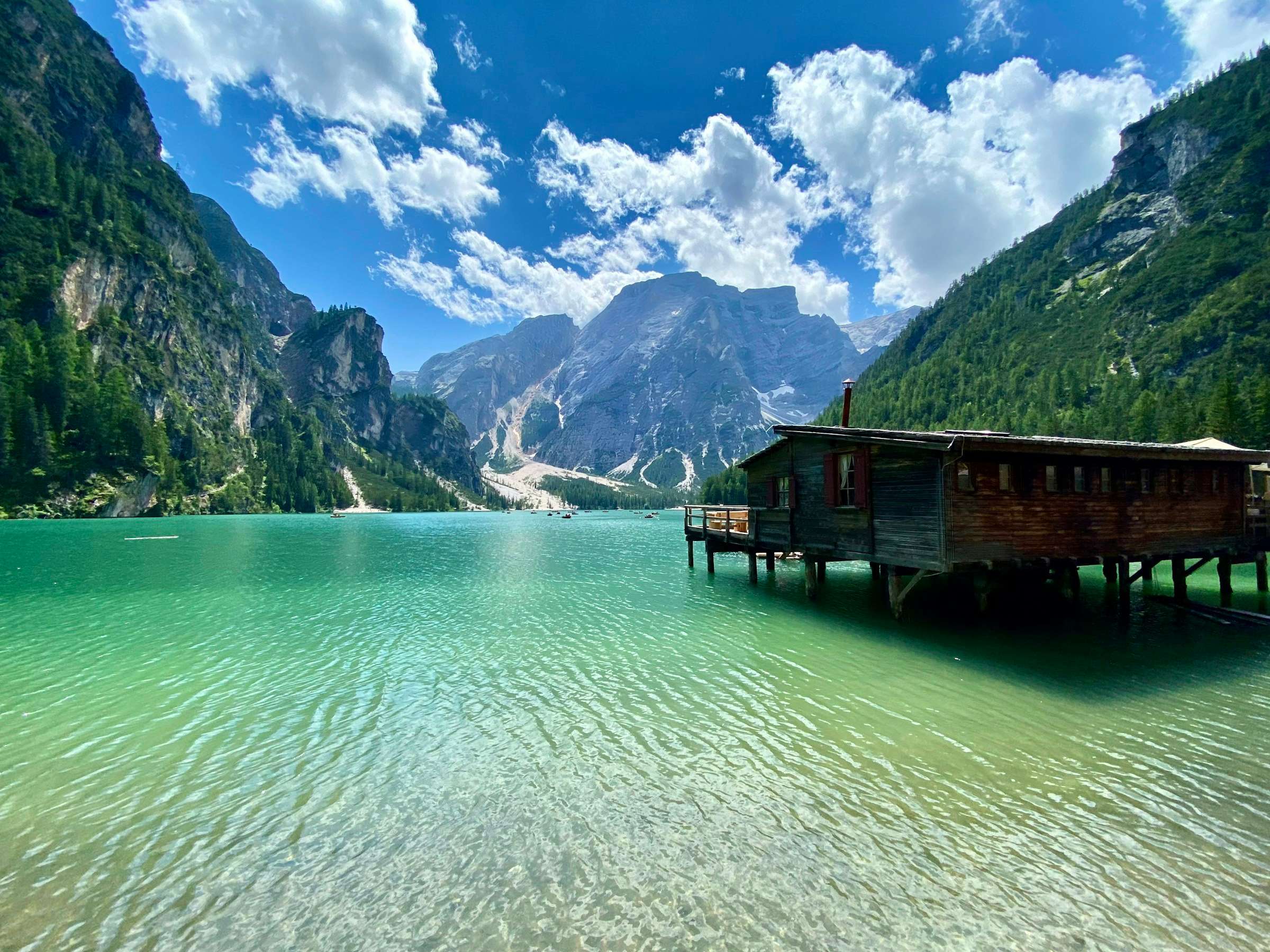 Bootshaus am Bergsee vor Dolomitengipfeln